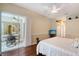Spacious bedroom with dark wood floors and access to the outdoor area, creating a tranquil setting at 7464 Ridge Rd, Sarasota, FL 34238