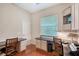 Home office with a granite desk, cabinets and a window with blinds to enjoy the natural light at 7464 Ridge Rd, Sarasota, FL 34238