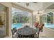 Inviting screened patio with ceiling fan, outdoor dining set, and view of the sparkling pool at 7464 Ridge Rd, Sarasota, FL 34238