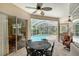 Inviting screened patio with ceiling fan, outdoor dining set, and view of the sparkling pool at 7464 Ridge Rd, Sarasota, FL 34238
