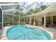 Outdoor living area with a screened pool, outdoor kitchen, and comfortable seating area at 7464 Ridge Rd, Sarasota, FL 34238