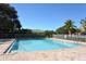 Community pool featuring a brick paver deck and a white fence surrounding the pool at 7464 Ridge Rd, Sarasota, FL 34238