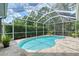 Screened pool area offers privacy and relaxation amongst well-manicured landscaping at 7464 Ridge Rd, Sarasota, FL 34238