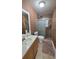 Cozy bathroom with warm brown walls, tiled floors, and updated fixtures, a convenient space for personal care at 809 30Th E Ave, Bradenton, FL 34208
