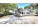 Charming single-Gathering home with ample parking and a quaint front porch nestled beneath lush, mature trees at 809 30Th E Ave, Bradenton, FL 34208