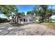 Charming single-Gathering home with ample parking and a quaint front porch nestled beneath lush, mature trees at 809 30Th E Ave, Bradenton, FL 34208