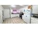 Bright kitchen featuring white cabinets, tile floors, and modern appliances, offering a functional space for cooking at 809 30Th E Ave, Bradenton, FL 34208