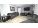 Cozy living room featuring neutral-toned walls, tile floors, and comfortable seating, perfect for relaxing and entertaining at 809 30Th E Ave, Bradenton, FL 34208