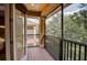Cozy screened-in balcony featuring wood floors and lovely view at 8168 Villa Grande Ct, Sarasota, FL 34243