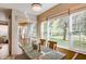 Bright dining area offering nature views and a sliding glass door to a screened patio at 8168 Villa Grande Ct, Sarasota, FL 34243