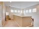 Upstairs hallway with an ornate light fixture, a leaning mirror and neutral paint at 8168 Villa Grande Ct, Sarasota, FL 34243