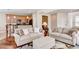 Inviting living room with two couches, a view of the kitchen, and hardwood floors at 8168 Villa Grande Ct, Sarasota, FL 34243