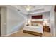 Comfortable main bedroom with tray ceiling, fan, and carpeted floors at 8168 Villa Grande Ct, Sarasota, FL 34243