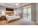 Bright main bedroom features a balcony and lots of natural light at 8168 Villa Grande Ct, Sarasota, FL 34243