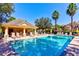 Community swimming pool with cabana, lounge chairs, and umbrellas at 8168 Villa Grande Ct, Sarasota, FL 34243
