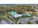 An aerial view of community amenities, including a pool, splashpad, clubhouse, playground, and parking at 8721 Firefly Pl, Parrish, FL 34219