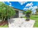 Open back patio with tile, a screen door, grill, tropical trees, and a beautiful view to the backyard at 8721 Firefly Pl, Parrish, FL 34219