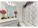 Bright bathroom with decorative pink flowers and tiled shower/tub combo at 8721 Firefly Pl, Parrish, FL 34219