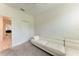 Cozy bedroom features plush carpeting, white sectional couch, and mounted TV at 8721 Firefly Pl, Parrish, FL 34219