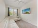 Cozy bedroom features plush carpeting, white sectional couch, and mounted TV at 8721 Firefly Pl, Parrish, FL 34219