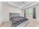 Spacious bedroom with tray ceiling and luxurious upholstered king-size bed at 8721 Firefly Pl, Parrish, FL 34219