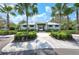 Community center featuring a walkway, sidewalk, lush landscape, and ample parking for residents and guests at 8721 Firefly Pl, Parrish, FL 34219