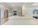 Modern kitchen featuring white cabinets, stainless steel appliances and light countertops at 8721 Firefly Pl, Parrish, FL 34219
