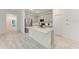 Open-concept kitchen featuring white cabinets, stainless steel appliances and light countertops at 8721 Firefly Pl, Parrish, FL 34219