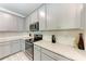 Bright kitchen featuring white cabinets, stainless steel appliances, and light countertops at 8721 Firefly Pl, Parrish, FL 34219