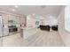 Open-concept living room featuring a sleek kitchen island and a plush couch at 8721 Firefly Pl, Parrish, FL 34219
