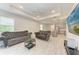 Open-concept living room with kitchen featuring a decorative ceiling fan at 8721 Firefly Pl, Parrish, FL 34219