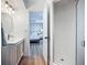 Bathroom with white vanity and shower, leading to bedroom at 912 Ponderosa Pine Ln, Sarasota, FL 34243