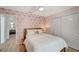 Cozy bedroom showcasing a ceiling fan, palm tree wallpaper, closet doors, and an open view into the bathroom at 912 Ponderosa Pine Ln, Sarasota, FL 34243