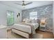 Comfortable bedroom with modern wallpaper, two windows, and a ceiling fan for a cool relaxing space at 912 Ponderosa Pine Ln, Sarasota, FL 34243