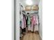 Organized walk-in closet featuring ample shelving, wooden floors, and hanging storage for clothes and accessories at 912 Ponderosa Pine Ln, Sarasota, FL 34243