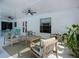 Comfortable covered patio with ample seating, a ceiling fan, and a wooden coffee table for enjoying the outdoors at 912 Ponderosa Pine Ln, Sarasota, FL 34243