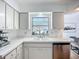 Bright, clean kitchen with white cabinets, stainless steel appliances, and a sunlit window with garden view at 912 Ponderosa Pine Ln, Sarasota, FL 34243