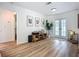 Bright living room with modern decor, featuring light wood floors, white walls, and stylish furnishings at 912 Ponderosa Pine Ln, Sarasota, FL 34243