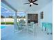 Cozy outdoor patio with comfortable seating, barbecue, and a ceiling fan for relaxing by the pool at 912 Ponderosa Pine Ln, Sarasota, FL 34243