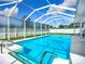 A screened-in pool with clear blue water offers a great view on a bright sunny day at 912 Ponderosa Pine Ln, Sarasota, FL 34243