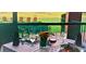 Elegant restaurant setting with golf course views, beautifully set table with floral arrangement and dinner at 912 Ponderosa Pine Ln, Sarasota, FL 34243
