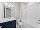 Full bathroom featuring blue vanity, shower over tub, toilet, and mirror for added functionality at 10309 Longmeadow Ave, Parrish, FL 34219