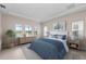Beautiful staged bedroom with a large window, stylish furniture and water view at 10309 Longmeadow Ave, Parrish, FL 34219