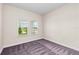 A bright, carpeted bedroom with two windows, perfect for relaxation and rest at 10309 Longmeadow Ave, Parrish, FL 34219