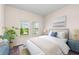 Bright bedroom featuring natural light, blue accents, and cozy furnishings at 10309 Longmeadow Ave, Parrish, FL 34219