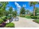 Community bikes ready to use next to a walking path, green space and lake at 10309 Longmeadow Ave, Parrish, FL 34219