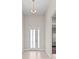 Bright foyer showcasing a decorative chandelier, stylish front door, and an open view into the home at 10309 Longmeadow Ave, Parrish, FL 34219