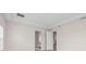 Hallway with neutral walls, tile floors, and doors leading to other rooms at 10309 Longmeadow Ave, Parrish, FL 34219