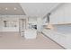Bright kitchen with stainless steel appliances, white cabinets, granite countertops, and a central island with barstool seating at 10309 Longmeadow Ave, Parrish, FL 34219