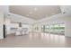 Open-concept kitchen featuring a modern design, stainless steel appliances, a center island, and sliding glass doors that lead to the pool at 10309 Longmeadow Ave, Parrish, FL 34219